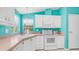 Well-equipped kitchen featuring modern appliances, white cabinets, and a charming design at 2400 E Baseline Ave # 44, Apache Junction, AZ 85119