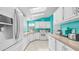 Bright and airy kitchen with white cabinets, modern appliances, and turquoise accents for a fresh, modern style at 2400 E Baseline Ave # 44, Apache Junction, AZ 85119