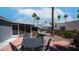 Outdoor patio features a table with chairs, brick pavers, tropical landscaping and sunny sky views at 2400 E Baseline Ave # 44, Apache Junction, AZ 85119