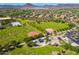 Aerial view of neighborhood park featuring lush green spaces, baseball fields, and playground at 29007 N 120Th Dr, Peoria, AZ 85383