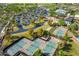 Aerial view of tennis courts and community pool with ample parking and mature landscaping at 29007 N 120Th Dr, Peoria, AZ 85383