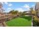 Well-manicured backyard showcasing a lush lawn, landscaped borders, and a charming pergola seating area at 29007 N 120Th Dr, Peoria, AZ 85383