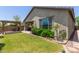 Beautiful backyard featuring a pergola-covered patio, lush lawn, and well-maintained landscaping at 29007 N 120Th Dr, Peoria, AZ 85383