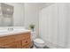 Well-lit bathroom with white countertop and bathtub with white shower curtain at 29007 N 120Th Dr, Peoria, AZ 85383