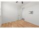 Open bedroom featuring light hardwood floors, ceiling fan, and a television mount at 29007 N 120Th Dr, Peoria, AZ 85383