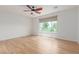 Spacious bedroom with wood floors, shiplap accent wall, ceiling fan and a window with a view at 29007 N 120Th Dr, Peoria, AZ 85383