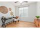 Bright bedroom featuring wood floors, white walls, a ceiling fan and a large window for plenty of natural light at 29007 N 120Th Dr, Peoria, AZ 85383