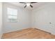 Clean, light bedroom featuring hardwood floors, ceiling fan, and closet with sliding doors at 29007 N 120Th Dr, Peoria, AZ 85383