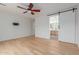 Large bedroom with wood floors, barn door to the bathroom, and a ceiling fan at 29007 N 120Th Dr, Peoria, AZ 85383