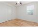 Bright bedroom with light hardwood floors and closet with sliding doors at 29007 N 120Th Dr, Peoria, AZ 85383