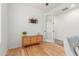 This bedroom is brightly lit, and features wood floors and a woven cabinet at 29007 N 120Th Dr, Peoria, AZ 85383
