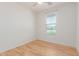 This bright bedroom has wood floors and a window overlooking the street at 29007 N 120Th Dr, Peoria, AZ 85383