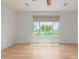 Bright, spacious bedroom featuring wood floors, shiplap wall, a ceiling fan and a large window with a view at 29007 N 120Th Dr, Peoria, AZ 85383