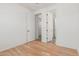 Bright bedroom with three doorways and wood floors at 29007 N 120Th Dr, Peoria, AZ 85383