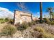 Stone community entrance sign surrounded by lush desert landscaping and clear blue skies at 29007 N 120Th Dr, Peoria, AZ 85383