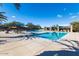 Stunning community pool featuring a modern design with comfortable lounge chairs and shade at 29007 N 120Th Dr, Peoria, AZ 85383