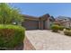 Attractive single-story house showcasing a paved driveway, a two-car garage, and well-maintained landscaping at 29007 N 120Th Dr, Peoria, AZ 85383