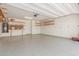 Spacious three car garage with epoxy flooring and custom shelving for storage at 29007 N 120Th Dr, Peoria, AZ 85383
