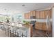 Spacious kitchen features granite countertops, a breakfast bar, stainless steel appliances, and maple wood cabinets at 29007 N 120Th Dr, Peoria, AZ 85383