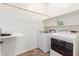 Bright laundry room with storage shelves and modern washer and dryer units at 29007 N 120Th Dr, Peoria, AZ 85383