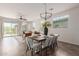 Open-concept space combines dining and living areas, featuring tile floors, neutral walls, and modern light fixture at 29007 N 120Th Dr, Peoria, AZ 85383