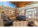 Community lobby featuring stone wall, cozy leather sofas, fireplace, and large windows, perfect for gathering and relaxation at 29007 N 120Th Dr, Peoria, AZ 85383