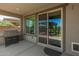 Covered patio with grill and sliding glass doors leading to backyard at 29007 N 120Th Dr, Peoria, AZ 85383