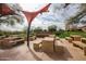 Outdoor community picnic area featuring multiple stone tables, benches, and grill, ideal for social gatherings and enjoying nature at 29007 N 120Th Dr, Peoria, AZ 85383