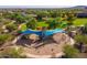 Community playground with shaded seating, swing sets, and climbing structures surrounded by lush trees at 29007 N 120Th Dr, Peoria, AZ 85383