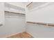 Large walk-in closet with wood floors, wood rods, and shelving at 29007 N 120Th Dr, Peoria, AZ 85383