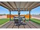 Inviting backyard with patio, dining set, and hot tub at 29408 N 224Th Dr, Wittmann, AZ 85361