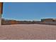 Expansive backyard with gravel landscaping and secure block wall fencing for added privacy at 29408 N 224Th Dr, Wittmann, AZ 85361