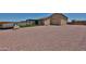 Backyard featuring artificial turf area, covered patio with pergola, and gravel landscaping at 29408 N 224Th Dr, Wittmann, AZ 85361