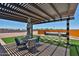 Inviting backyard patio with pergola, artificial grass, spa and pavers offers a perfect place for outdoor entertaining at 29408 N 224Th Dr, Wittmann, AZ 85361