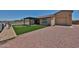 Expansive backyard with artificial turf, hot tub, and covered patio perfect for relaxing and outdoor living at 29408 N 224Th Dr, Wittmann, AZ 85361
