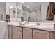 Bathroom features dual sinks with ample counter space, wooden drawers and cabinet at 29408 N 224Th Dr, Wittmann, AZ 85361