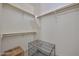 Walk-in closet with custom shelves, wooden rails, and plenty of room for storage at 29408 N 224Th Dr, Wittmann, AZ 85361