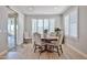 Cozy dining room featuring a round table, chairs, tile floors, plantation shutters, and sliding glass doors at 29408 N 224Th Dr, Wittmann, AZ 85361