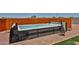 Luxury hot tub features a towel rack and removable side panels situated on a paver and artificial grass patio at 29408 N 224Th Dr, Wittmann, AZ 85361