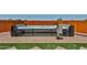 Luxury hot tub features a towel rack and removable side panels situated on a paver and artificial grass patio at 29408 N 224Th Dr, Wittmann, AZ 85361
