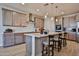 Modern kitchen with stylish island, pendant lighting, stainless steel appliances, and tile backsplash at 29408 N 224Th Dr, Wittmann, AZ 85361