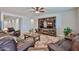 Spacious living room with hardwood floors, a leather sofa set, and a decorative media center at 29408 N 224Th Dr, Wittmann, AZ 85361