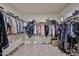 Spacious walk-in closet with dual hanging racks and carpeted floors at 29408 N 224Th Dr, Wittmann, AZ 85361