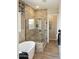 Luxurious bathroom featuring a freestanding tub, tiled shower, and modern fixtures at 37795 W Padilla St, Maricopa, AZ 85138