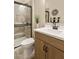 Well-lit bathroom with a large vanity, sleek hardware, and a glass-enclosed shower at 37795 W Padilla St, Maricopa, AZ 85138