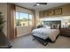 Bright bedroom with a large window, stylish bench, and tasteful decor at 37795 W Padilla St, Maricopa, AZ 85138