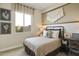 Comfortable bedroom with neutral walls, natural light from the window, and decor on the wall at 37795 W Padilla St, Maricopa, AZ 85138