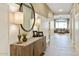 Hallway with wood floors leads to a bright, open living room area at 37795 W Padilla St, Maricopa, AZ 85138