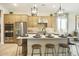 Modern kitchen with an island, stainless steel appliances, pendant lighting, and ample cabinet space at 37795 W Padilla St, Maricopa, AZ 85138