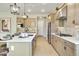Spacious kitchen with a center island, stainless steel appliances, and seamless transition to other living spaces at 37795 W Padilla St, Maricopa, AZ 85138